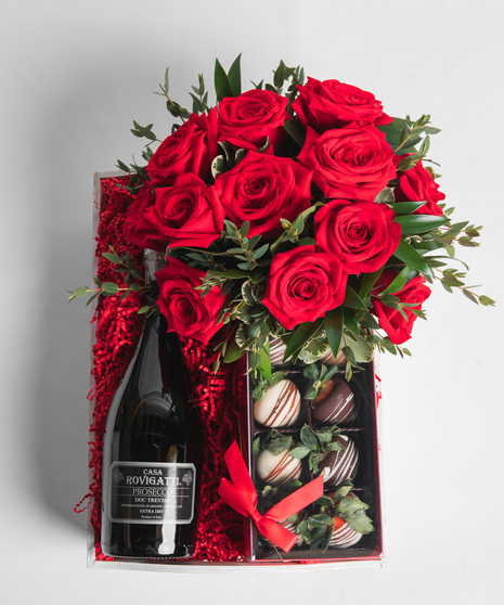 Your choice of wine is nestled into a wooden crate with a vase arrangement of a dozen vibrant red roses and a 4 pack of decadent chocolate-covered strawberries