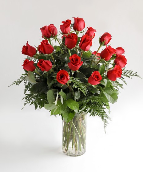 Variations of a dozen red roses in a glass vase.