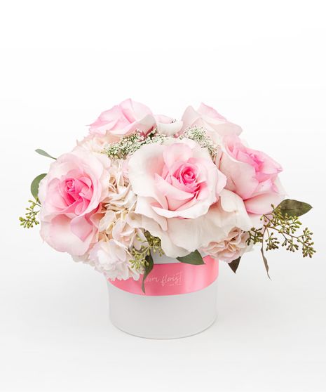 Beautiful cybidium orchids, roses, stock, hydrangea and more are elegantly designed in a clear glass bubble bowl vase