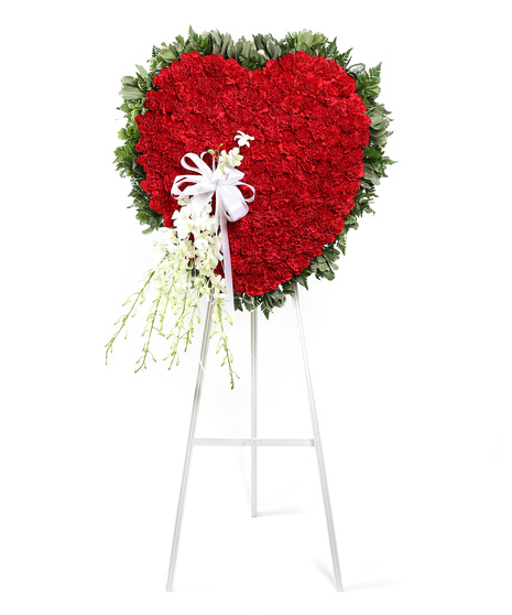The Devotion Standing Heart is a beautiful display of red carnations and white dendrobiums to create an exquisite way to honor the life of the deceased.