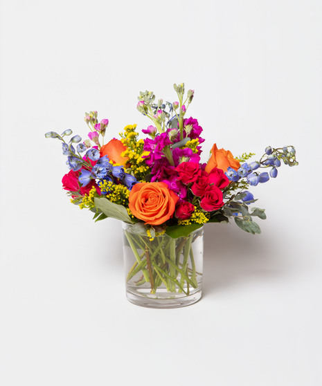 Born to be Wild is a vibrant fusion of hot pink and orange blooms designed to ignite joy and celebrate birthdays with flair. 