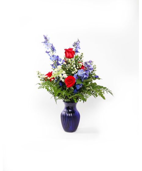 A striking display of red, white, and blue patriotic petals that will deliver your condolences to the bereaved.