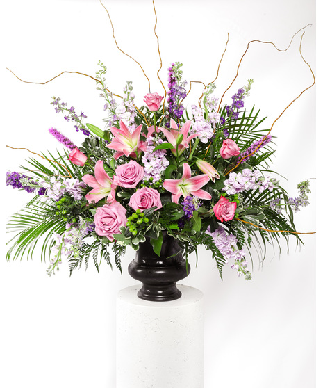This perfect end piece for a funeral display features pink and purple blooms with lush greenery that symbolizes heartfelt sympathy.