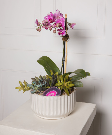 Lavender & Jewels features a rich palette of purple blooms, exuding grace and beauty, presented in a chic purple vase.