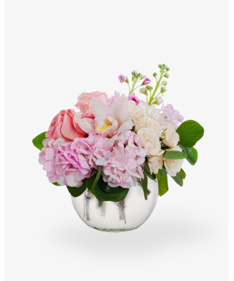 Beautiful cybidium orchids, roses, stock, hydrangea and more are elegantly designed in a clear glass bubble bowl vase